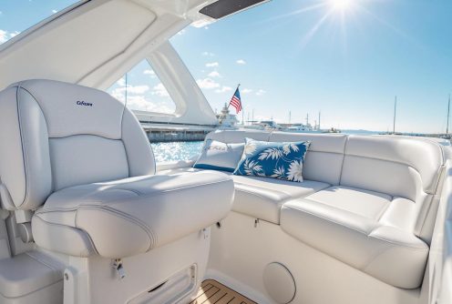 A luxurious yacht seating area with soft, white upholstery, showcasing expert Boat Canvas and Upholstery Maintenance in a marina setting. A luxurious yacht seating area with soft, white upholstery, showcasing expert Boat Canvas and Upholstery Maintenance in a marina setting.