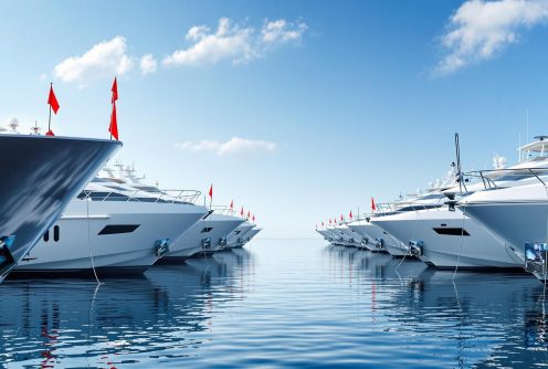 A row of luxury yachts docked in a marina, showcasing professional yacht management services. A row of luxury yachts docked in a marina, showcasing professional yacht management services.