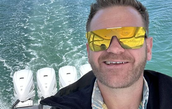 A happy customer enjoying a smooth ride after expert boat repairs by Boat Repair Near Me.