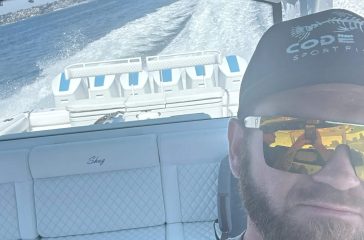 A satisfied customer from Boat Repair Near Me taking a test run after a boat service in San Diego.