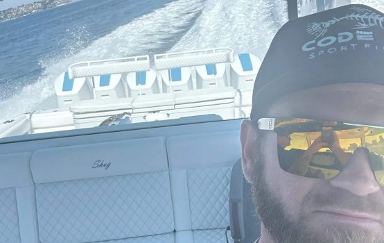 A satisfied customer from Boat Repair Near Me taking a test run after a boat service in San Diego.