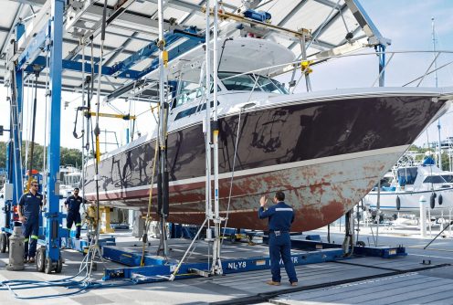 A boat being precisely lifted with advanced dock equipment. Dry Dock and Haul-Out Services ensures efficiency and care in every haul-out.