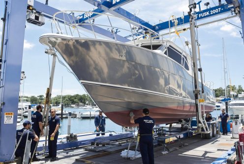 A boat being prepped for hull sanding and refinishing at a dry dock. Dry Dock and Haul-Out Services provides complete restoration solutions.