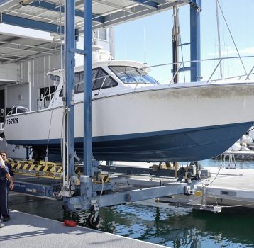 A team inspecting and repairing a boat with visible hull corrosion. Dry Dock and Haul-Out Services prevents long-term marine damage.