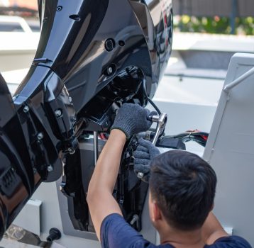 man-repairing-boat-with-tools