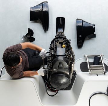 A technician performing marine engine repair on a boat, ensuring optimal performance and reliability for safe navigation.